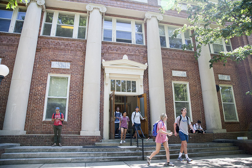 Historic Peabody hall in spring as students leave during a class change